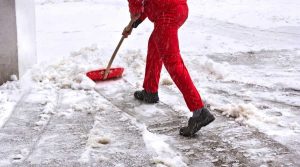 person shoveling snow from driveway