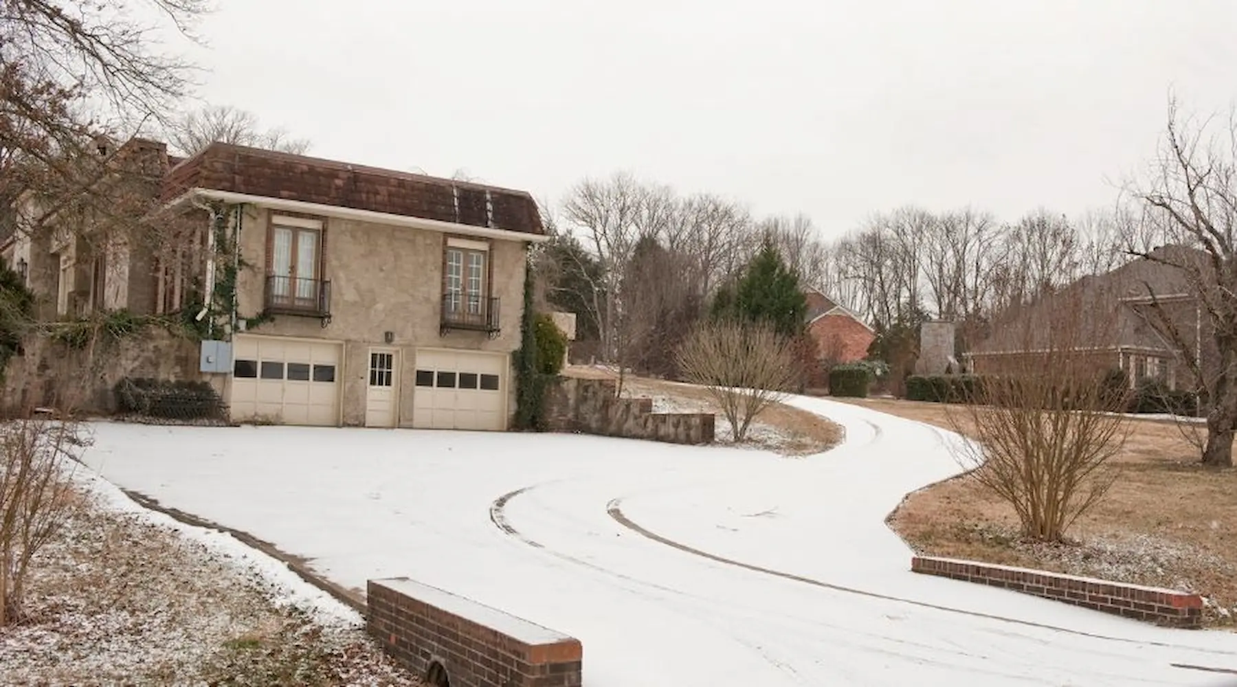 House with snow in driveway