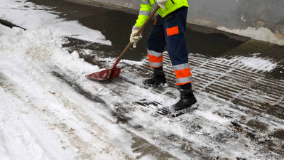 person shoveling snow from driveway